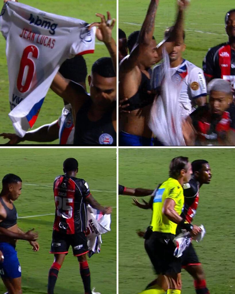 Cacá, zagueiro do Vitória, tenta rasgar camisa do Bahia após Jean Lucas marca gol e mostrá-la para torcida; árbitro Raphael Claus intervém para conter confusão no clássico Ba-Vi